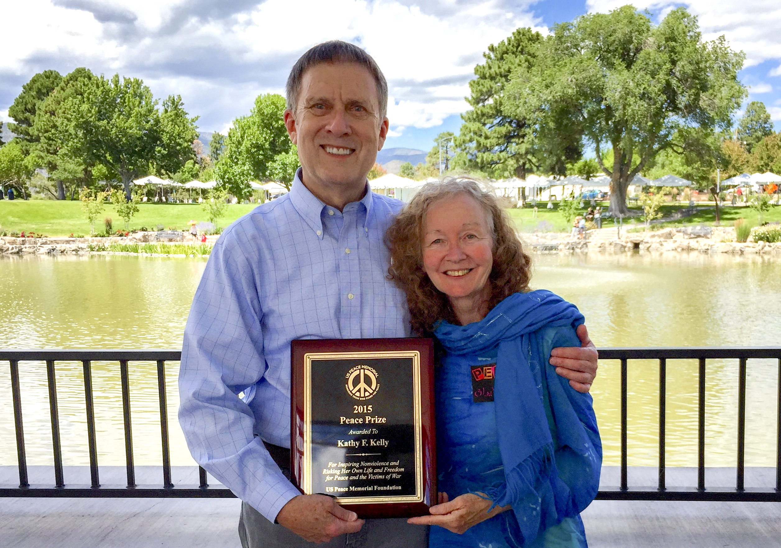 Kathy Kelly with Michael holding Peace Prize